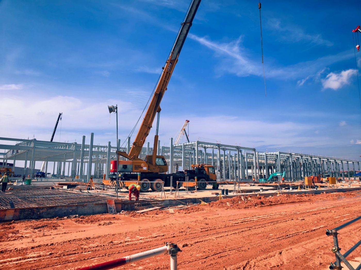 Mobile crane beside a steel structure
